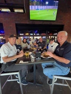 Veterans share stories around a table at the Fifth Friday social mixer.